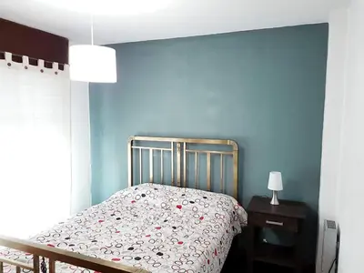 a bedroom with a bed and a blue wall at DPTO ZONA PATIO OLMOS in Cordoba