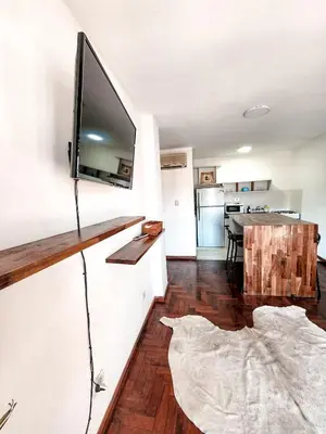a living room with a flat screen tv on a wall at DPTO ZONA PATIO OLMOS in Cordoba