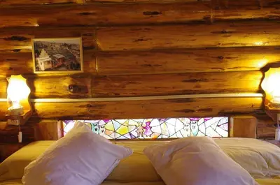a bedroom with a wooden wall and a stained glass window at Cabañas Am Hang in La Cumbrecita