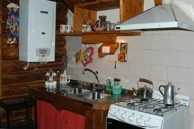a kitchen with a sink and a stove at Cabañas Am Hang in La Cumbrecita
