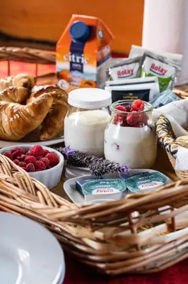 a picnic basket with bread and yogurt and other foods at Akapana Suites in La Cumbrecita