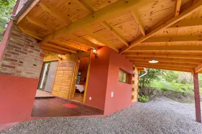 a wooden roof over a porch of a house at Akapana Suites in La Cumbrecita