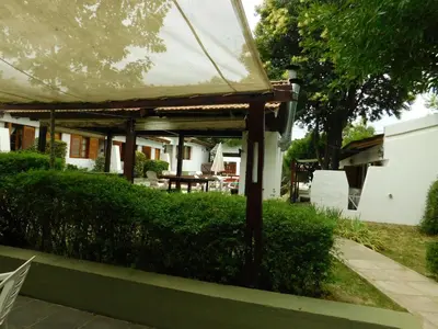 a pavilion with a table and chairs in a yard at El Agora in Villa General Belgrano