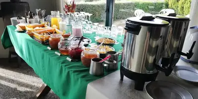 a table with a green table cloth with food on it at Hotel Panorama in La Cumbrecita