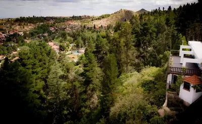 an aerial view of a forest with a house at Hotel Panorama in La Cumbrecita