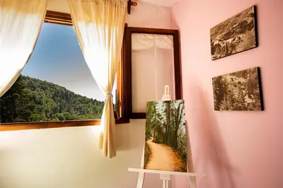 a room with a window with a picture on the wall at Hotel Panorama in La Cumbrecita