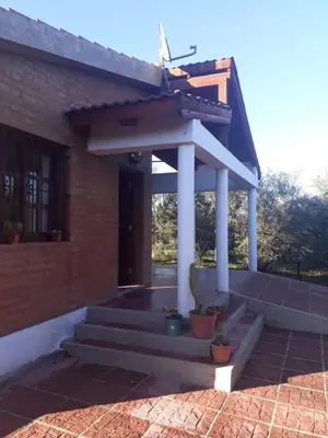 a house with a porch and stairs in front at Tacko Huasi in San Javier