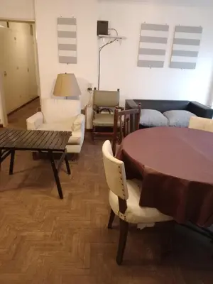 a living room with a table and chairs and a couch at Confortable en Cofico in Cordoba