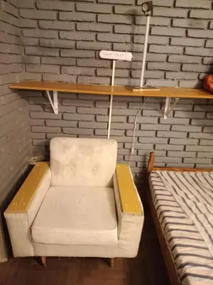 a white chair sitting on a shelf next to a bed at Confortable en Cofico in Cordoba