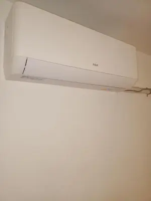 a white air conditioner hanging from a ceiling at Confortable en Cofico in Cordoba