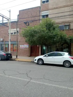 a white car parked in front of a building at Confortable en Cofico in Cordoba
