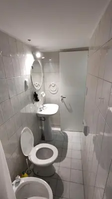 a bathroom with a toilet and a sink at La Escalerita- Estadio Kempes in Cordoba