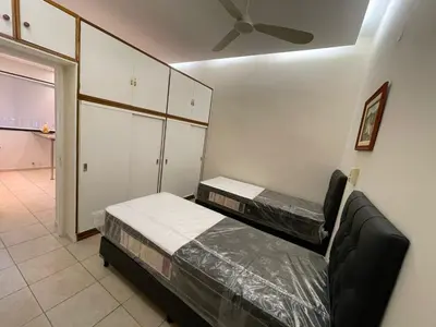 two beds in a room with a ceiling fan at La Escalerita- Estadio Kempes in Cordoba
