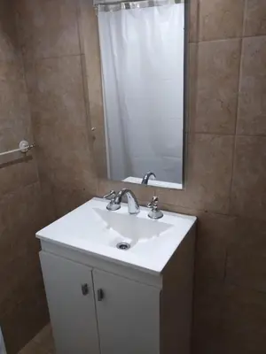 a bathroom with a white sink and a mirror at Casita Misol con piscina exclusiva y 100 mts del rio in Villa Carlos Paz