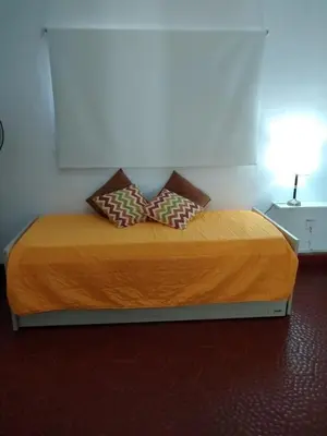 a bed with two pillows on it in a room at Casita Misol con piscina exclusiva y 100 mts del rio in Villa Carlos Paz