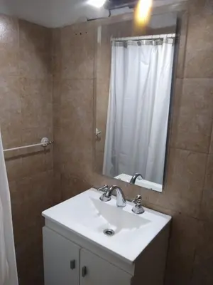 a bathroom with a sink and a mirror and a shower at Casita Misol con piscina exclusiva y 100 mts del rio in Villa Carlos Paz