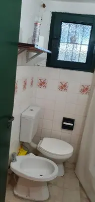 a bathroom with a toilet and a window at Cabañas La Escondida Casa De Campo 2 in San Antonio de Arredondo