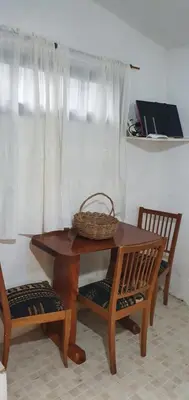 a table with two chairs and a basket on top at Cabañas La Escondida Casa De Campo 2 in San Antonio de Arredondo