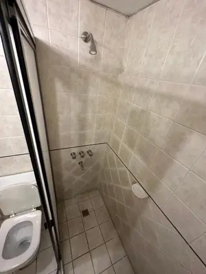 a bathroom with a shower and a toilet at Apart Hotel Bari in Cordoba