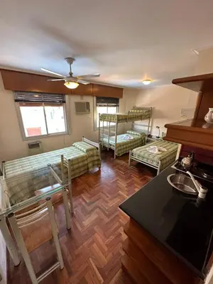 a living room with two bunk beds and a table at Apart Hotel Bari in Cordoba