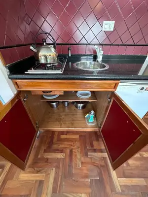 a kitchen with a sink and a counter top at Apart Hotel Bari in Cordoba