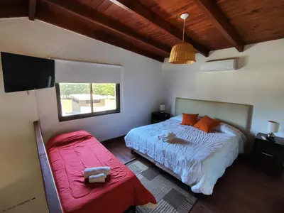 a bedroom with a bed and a flat screen tv at Complejo Boulevard in Villa Ciudad de America