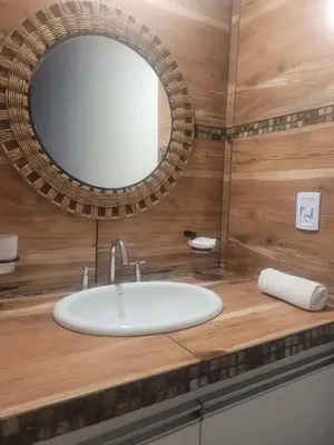 a bathroom with a sink and a mirror on a counter at Complejo Boulevard in Villa Ciudad de America