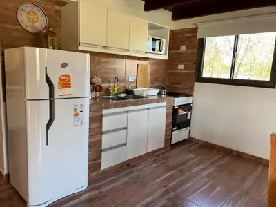 a kitchen with a white refrigerator and a sink at Complejo Boulevard in Villa Ciudad de America