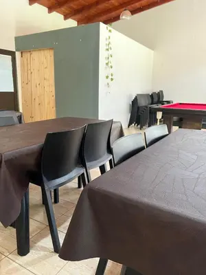 a room with a ping pong table and chairs at Complejo Boulevard in Villa Ciudad de America