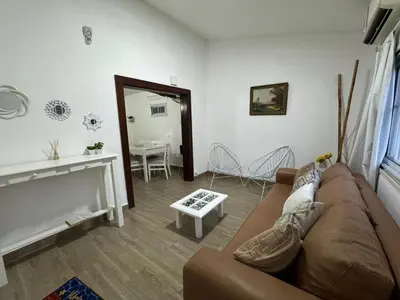a living room with a couch and a table at Casa Paz in Villa Carlos Paz