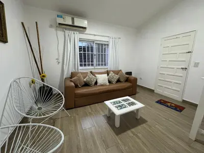 a living room with a couch and a table at Casa Paz in Villa Carlos Paz