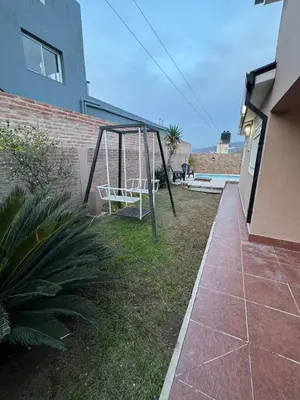 a swing in the backyard of a house at Casa Paz in Villa Carlos Paz