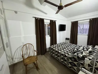 a bedroom with a bed and a ceiling fan at Casa Paz in Villa Carlos Paz