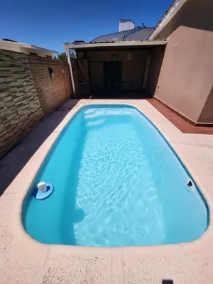 a large blue swimming pool on top of a house at Casa Paz in Villa Carlos Paz