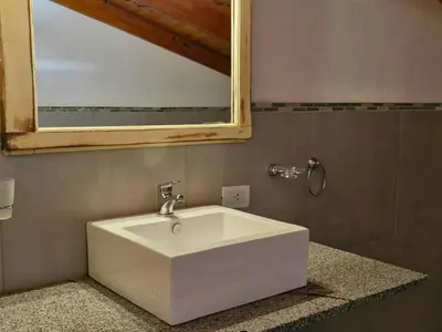 a white sink in a bathroom with a mirror at Posada Faro Serrano in Villa General Belgrano