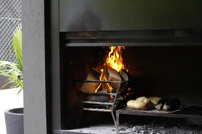 a fireplace with a bunch of food in it at Faz Hostel Boutique in Cordoba