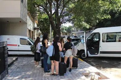 a group of girls standing outside of a white van at Faz Hostel Boutique in Cordoba