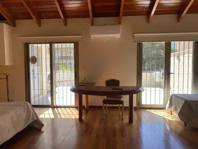a room with a table in the middle of a bedroom at categoria a 1 cuadra plaza espana in Cordoba