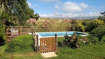 a fence around a swimming pool in a yard at LA LINDA - Cabaña de Montaña in Villa Berna