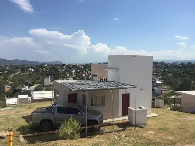 a truck parked in front of a house at Vista del Lago in Villa Carlos Paz