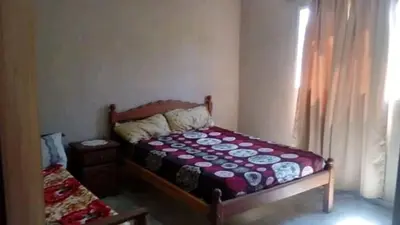 a bedroom with a bed and a window at Vista del Lago in Villa Carlos Paz