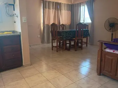 a dining room with a table and four chairs at Vista del Lago in Villa Carlos Paz