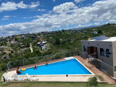 a large swimming pool on top of a house at Vista del Lago in Villa Carlos Paz