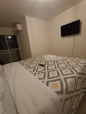 a bedroom with a bed with a television on the wall at Cofico Ideal in Cordoba
