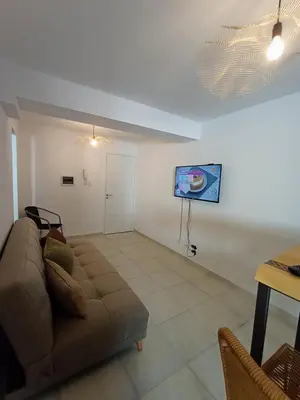 a living room with a couch and a tv on the wall at Cofico Ideal in Cordoba