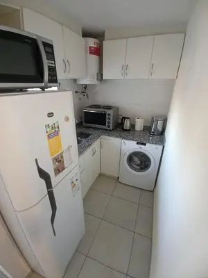 a small kitchen with a refrigerator and a microwave at Cofico Ideal in Cordoba