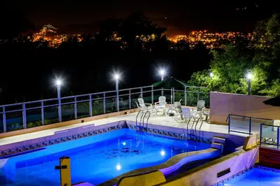 a swimming pool at night with a view of a city at Estrella de Mar in Villa Carlos Paz