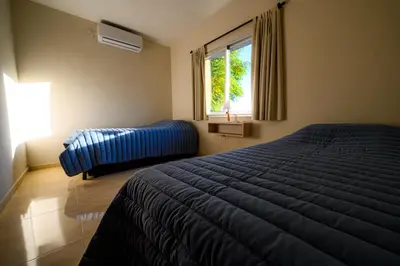 a bedroom with a blue bed and a window at Estrella de Mar in Villa Carlos Paz