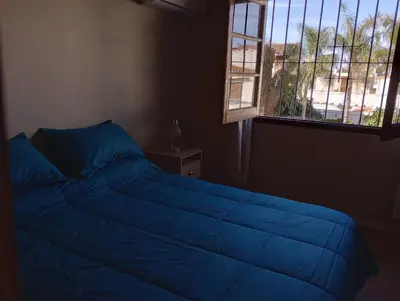 a blue bed in a bedroom with a window at Casa Lucerna in Cordoba