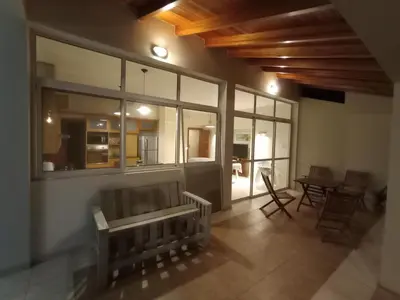 a room with a bench and a table and windows at Casa Lucerna in Cordoba